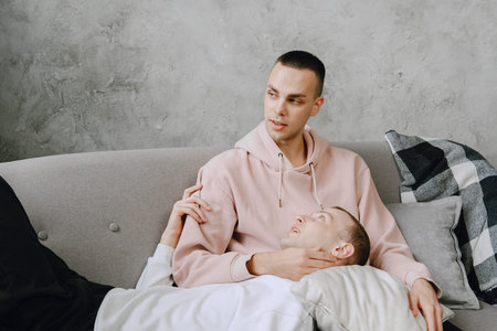 Young romantic gay couple spending day cuddling