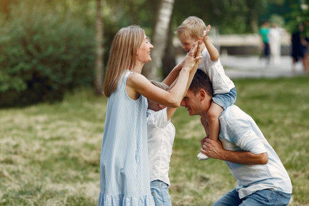 Cute family playing in a summer field