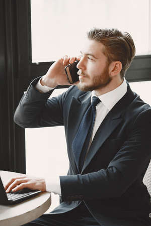 Man sitting with laptop in a cafeの写真素材