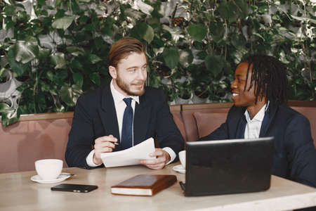 Two internatioal businessmen at the restaurantの写真素材