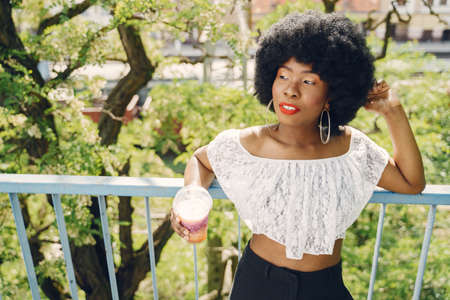 Portrait beautiful smiling african woman in city closeupの写真素材