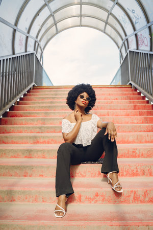 Portrait beautiful smiling african woman in city closeupの写真素材