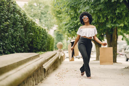 Portrait beautiful smiling african woman in city closeupの写真素材