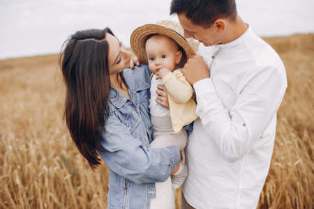 Cute family playing in a autumn fieldの写真素材