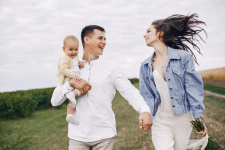 Cute family playing in a autumn fieldの写真素材