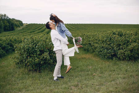 Beautiful couple spend time on a summer fieldの写真素材
