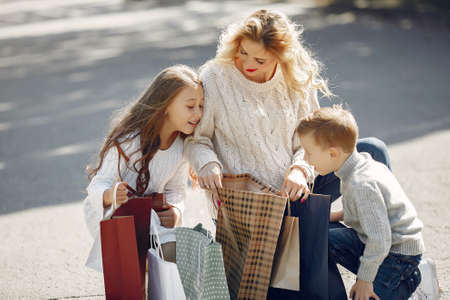 Mother with child with shopping bag in a cityの写真素材