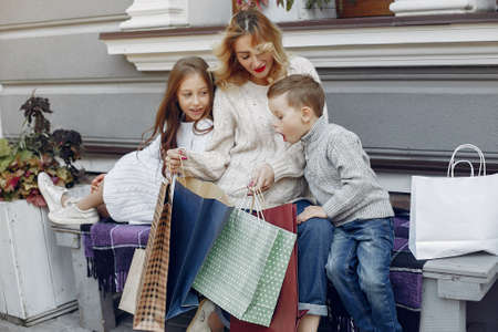 Mother with child with shopping bag in a cityの写真素材