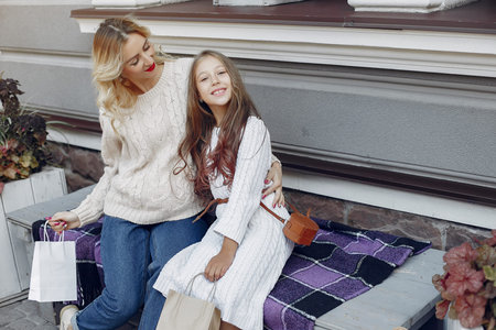 Mother with child with shopping bag in a city