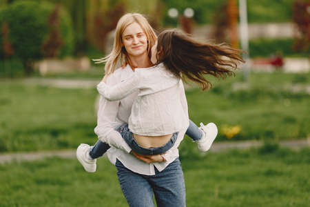 Elegant mother with daughter in a summer forestの写真素材