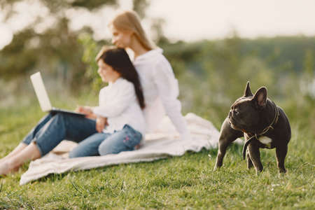 Elegant mother with daughter in a summer forestの写真素材