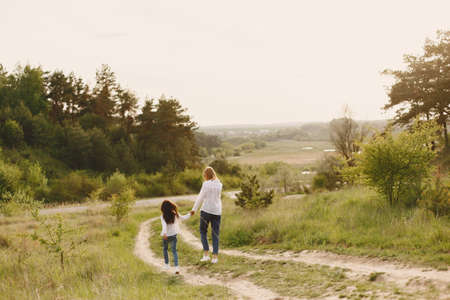 Elegant mother with daughter in a summer forestの写真素材