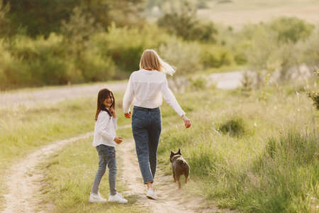 Elegant mother with daughter in a summer forestの写真素材