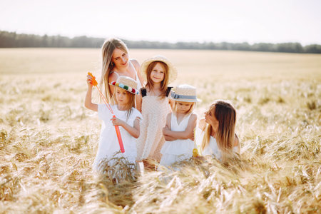 Mothers with daughters playing in a autumn fieldの写真素材