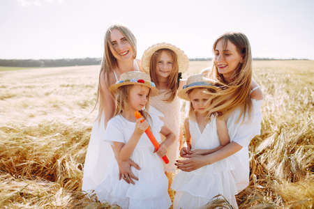 Mothers with daughters playing in a autumn fieldの写真素材