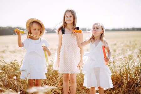 Beautiful girls have fun in a autumn fieldの写真素材