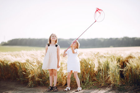 Beautiful girls have fun in a autumn fieldの写真素材