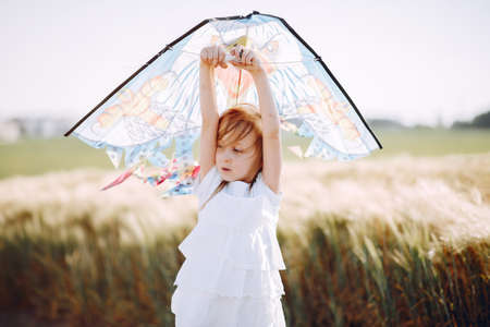 Cute child spend time on a summer fieldの写真素材
