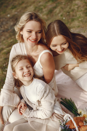 Elegant mother with children in a summer forestの写真素材