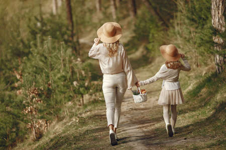Elegant mother with daughter in a summer forestの写真素材