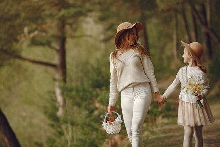 Elegant mother with daughter in a summer forestの写真素材