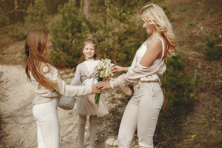 Elegant mother with children in a summer forestの写真素材