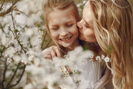 Elegant mother with daughter in a summer forestの写真素材