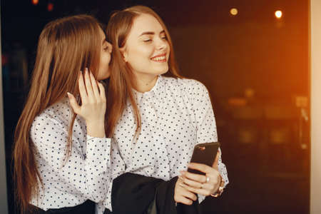 twins with phoneの写真素材