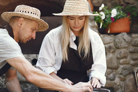 People making a vaze from a clay on a potterys machineの写真素材