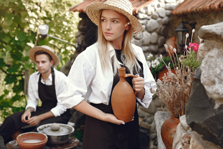 People making a vaze from a clay on a potterys machineの写真素材