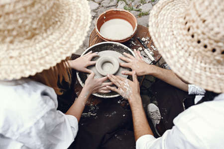 People making a vaze from a clay on a potterys machineの写真素材