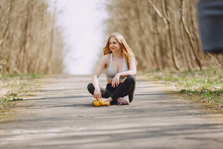Sports girl training in a summer forestの写真素材