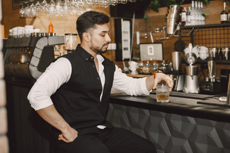 Handsome man at the bar with whiskey
