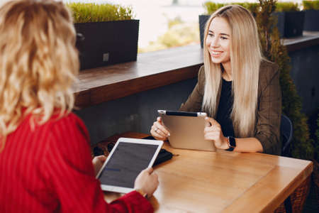 Two businesswomen working in a cafeの写真素材