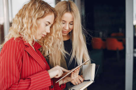 Two businesswomen working in a cafeの写真素材