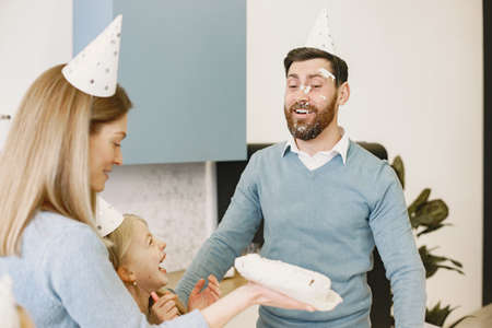 Family celebrating birthday in the kitchenの写真素材