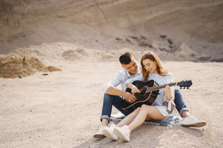 Young couple in love in sand careerの写真素材