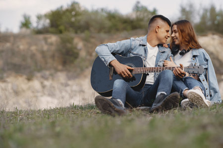 Young couple in love in a career with a guitar