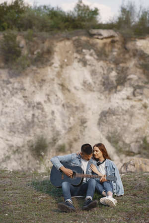 Young couple in love in a career with a guitarの写真素材