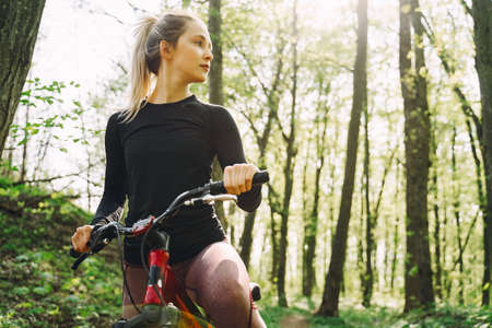 Woman riding a mountain bike in the forestの写真素材