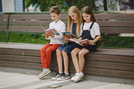 Happy children sitting together close and smileの写真素材