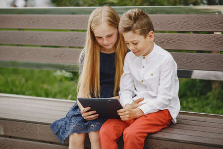 Happy children sitting together close and smileの写真素材