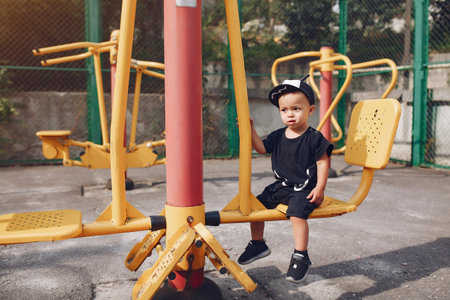 Cute little boy have fun on a playgroundの写真素材