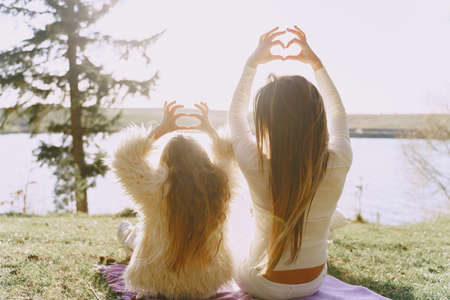 Elegant mother with daughter in a summer forestの写真素材