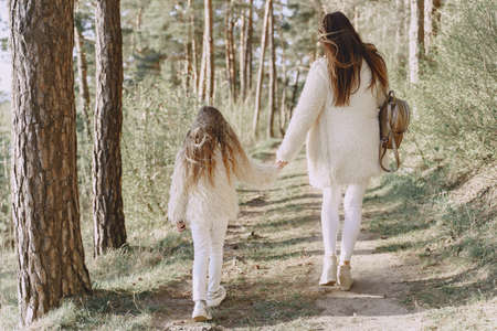 Elegant mother with daughter in a summer forestの写真素材