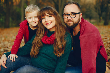 Family with little son in a autumn park
