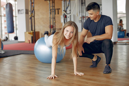 Young sports people training in a morning gym