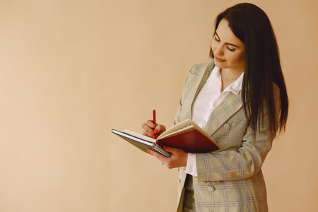 Woman standing on a brown background