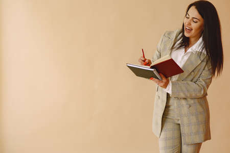 Woman standing on a brown backgroundの写真素材