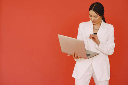 Woman standing on a red backgroundの写真素材
